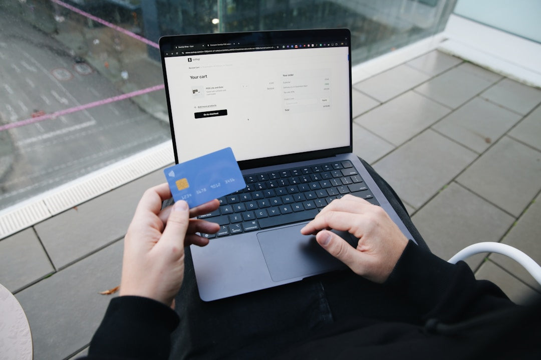 A person shopping online on a laptop with a credit card, representing modern eco-friendly shopping trends